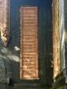 close view of upper dedicatory panel to right of door