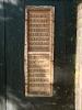close view of  lower dedicatory panel to right of door 
