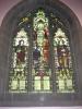 Large three-light stained glass window, depicting Christ blessing a soldier and sailor, flanked by St. Stephen and St. Alban. The window incorporates the Huddersfield coat of arms, a fleur de lys, and a cross, crown and keys (signifying the Kingdom of God). The lower panes bear the inscription.