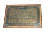 Plaque fixed to wooden backboard