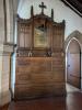 Elaborately carved wood reredos with brass plaque attached