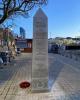 Obelisk memorial with poppy wreath on the left hand side floor.