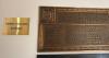 Another explanatory plaque adjacent to the memorial plaque.