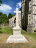 Plain stone cross atop square plinth
