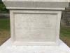 Plain stone cross atop square plinth