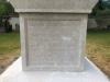 Plain stone cross atop square plinth
