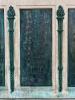 Five bronze plaques mounted on each side of large stone plinth