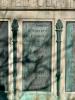 Five bronze plaques mounted on each side of large stone plinth
