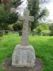 Rough hewn cross with uneven base and inscription