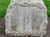 Rough hewn cross with uneven base and inscription