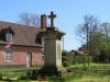 Plain cross atop square column with inscription