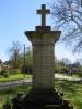 Plain cross atop square column with inscription