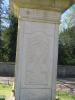 Plain cross atop square column with inscription
