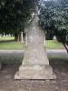 Stone family gravestone topped with a draped urn