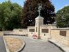 Curved wall with statue of soldier on plinth