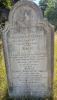 A gravestone with a high rounded top and Scotia shoulders with one name in addition too those remembered.