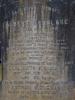 Leaded lettering on a gravestone.
