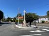 Stone cross in centre of road