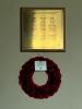 Brass plaque on wooden board