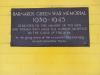 Brass plaque dedicating Bus Shelter in memory of those that died in WW2 from the area