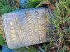 A marble vase withing a kerbed grave