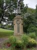 Figure on top of a stone pillar