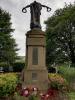 Figure on top of  stone pillar