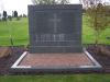 A square free standing granite stone, with a small red gravel square in front. The memorial refers to the 15 people with no known grave from WW1 from this area