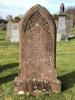 Gothic shaped red stone gravestone