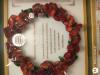 Close up of central poppy wreath with commemoration inscribed within