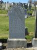 Granite gravestone with a fully rounded top.