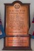 Inscribed metal plaque on wall of church.
