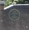 Close up of plaque on wall at entrance
