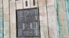 One of the wall mounted metal plaques with inscriptions in relief, on rusticated stone walls at bottom of tower.