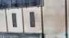 One of the wall mounted metal plaques with inscriptions in relief, on rusticated stone walls at bottom of tower.