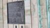 One of the wall mounted metal plaques with inscriptions in relief, on rusticated stone walls at bottom of tower.