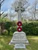 Rough hewn celtic cross with inscribed names and tablet in front