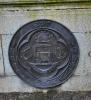 Bronze medallion on rear of wall