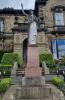 The front of the memorial where a statue of a woman stands atop a plinth.