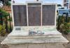 Stone wall with 3 bronze plaques and small additional plaque