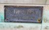 Small bronze plaque with a single name