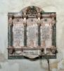 Three incised panels with family coat of arms at top