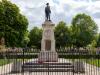 Stone plinth with cast metal statue of a soldier on top. 