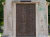 Cast bronze plaque with raised lettering.