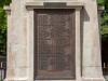 Cast bronze plaque with raised lettering.