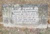 A kerbed grave with a granite gravestone with a flat top and one name in addition to that remembered