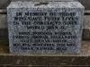 Incised lettering on a grey granite plaque.