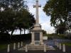 A war memorial in form of a cross on a plinth.