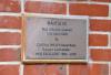 Plaque by entrance to building