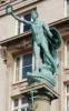 The figure atop the column